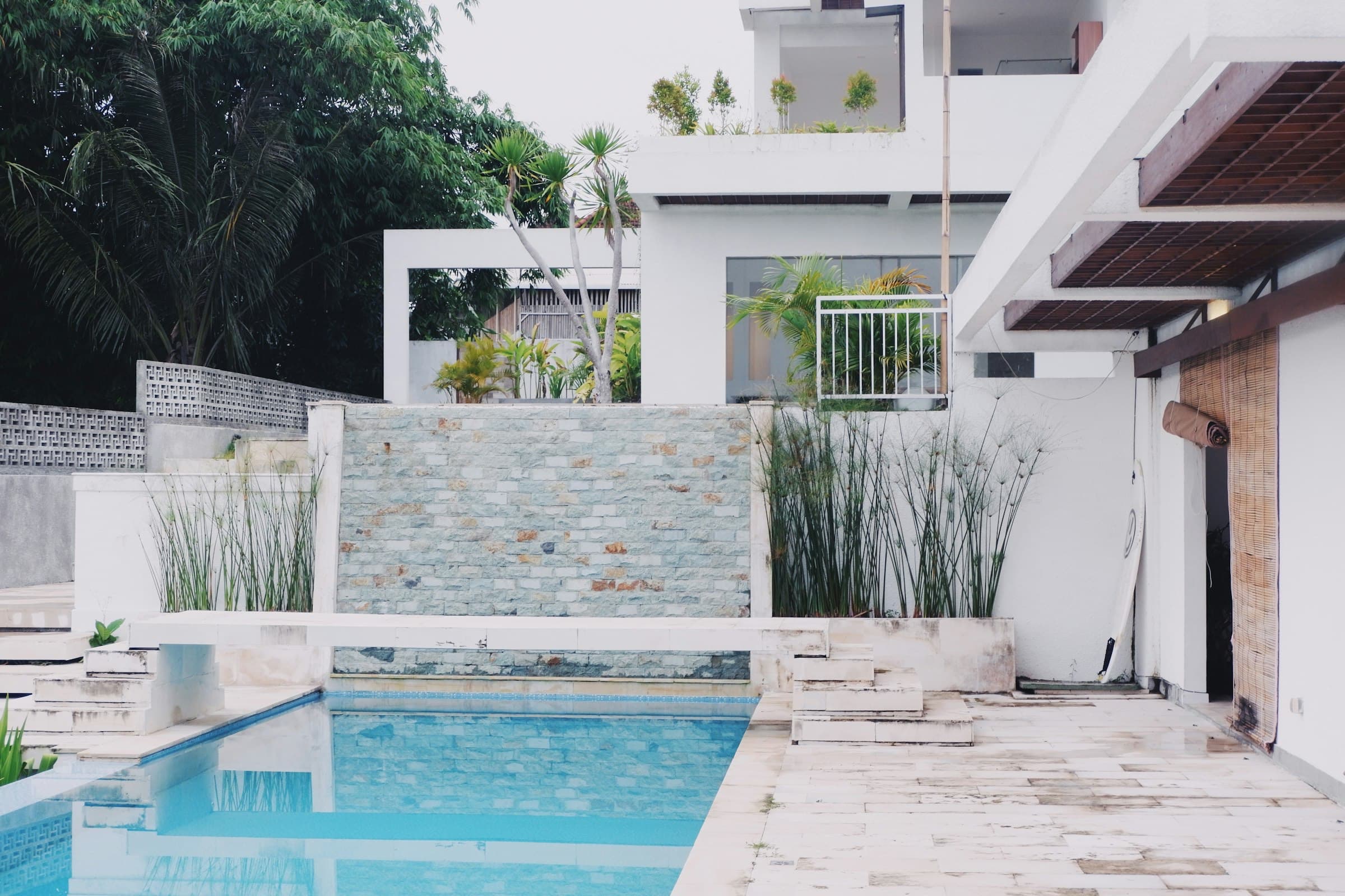 White villa terraces with a stone stair and pool on a hillside